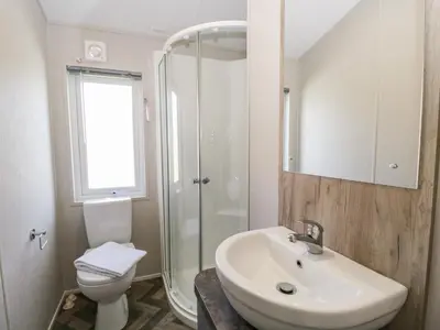 a bathroom with a sink and a toilet and a shower at Parkers Place in Carnforth