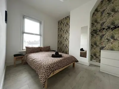 a bedroom with a bed and a window at Sunnyside Aparthotel Safari suite, Free Parking, 10Min Walk To Blackpool tower in Blackpool