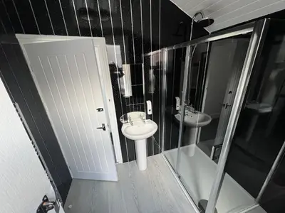a bathroom with a toilet and a sink and a shower at Sunnyside Aparthotel Safari suite, Free Parking, 10Min Walk To Blackpool tower in Blackpool