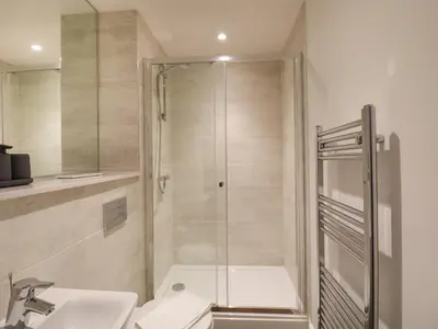 a bathroom with a shower and a sink at Alice House Stone Cross Mansion in Ulverston