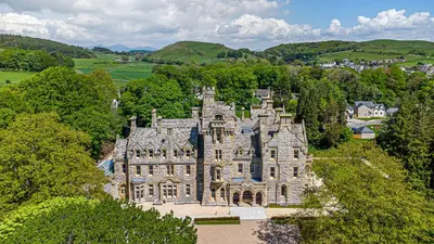 an aerial view of a large building with trees at Alice House Stone Cross Mansion in Ulverston