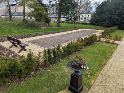 a park with a bench and a walkway at Alice House Stone Cross Mansion in Ulverston