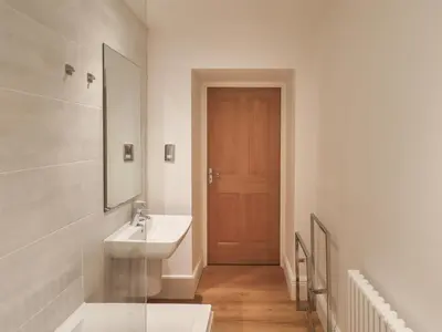 a bathroom with a sink and a mirror at The Kathleen Suite Stone Cross Mansion in Ulverston