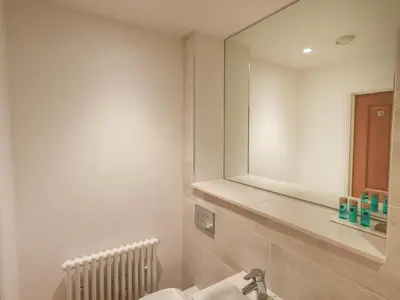 a bathroom with a sink and a mirror at The Kathleen Suite Stone Cross Mansion in Ulverston