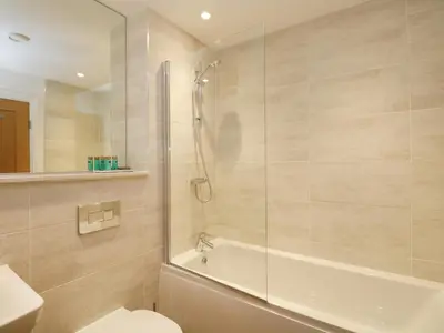 a bathroom with a shower and a toilet and a sink at The Florence Suite Stone Cross Mansion in Ulverston