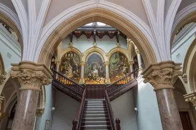 a staircase in a building with a painting on the wall at The Florence Suite Stone Cross Mansion in Ulverston