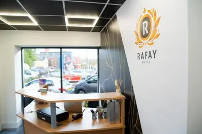 an office with a raaky sign on the wall at Hotel Rafay in Blackburn
