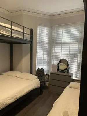 a bedroom with two bunk beds and a dresser and a mirror at 264 The Road End in Liverpool
