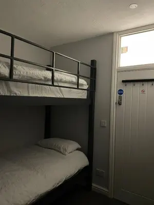 a bedroom with two bunk beds and a window at 264 The Road End in Liverpool
