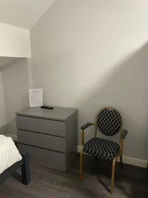 a bedroom with a bed and a dresser and a chair at 264 The Road End in Liverpool