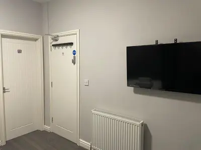 a room with a flat screen tv on a wall at 264 The Road End in Liverpool