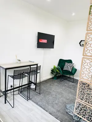 a dining room with a table and a chair at Lovely Estelle Studio Apartment by CityNest in Blackpool