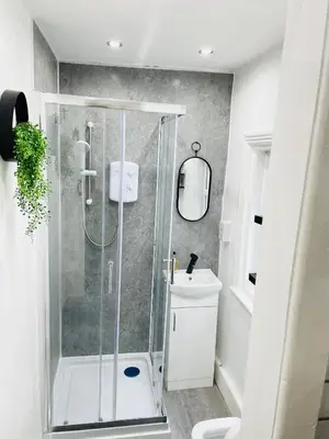 a bathroom with a shower and a toilet and a sink at Lovely Estelle Studio Apartment by CityNest in Blackpool