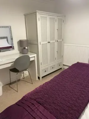 a bedroom with a desk and a bed and a chair at Burlington Cottage - Ulverston, Lake District. in Ulverston