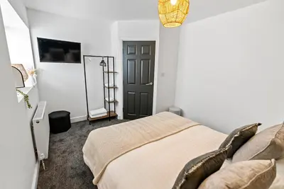 a bedroom with a bed and a black door at The Snug at The Hideaway STAMP SA in Blackpool