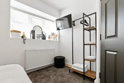 a bedroom with a bed and a book shelf at The Snug at The Hideaway STAMP SA in Blackpool