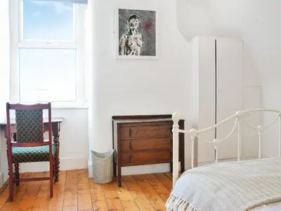 a bedroom with a bed and a desk and a chair at Anfield Haven in Liverpool