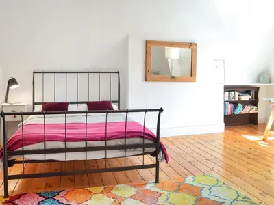 a bedroom with a bed and a mirror on the wall at Anfield Haven in Liverpool