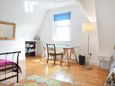 a room with a table and chairs and a window at Anfield Haven in Liverpool