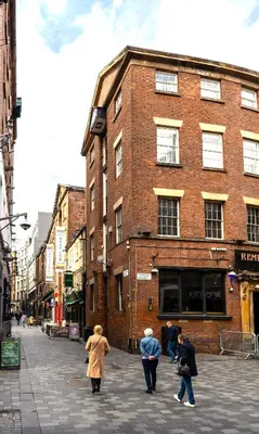 a group of people walking down a city street at The Cavern Quarter Aparthotel by UStay in Liverpool