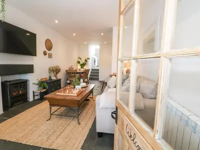 a living room with a couch and a table at Sandacre Cottage in Ulverston