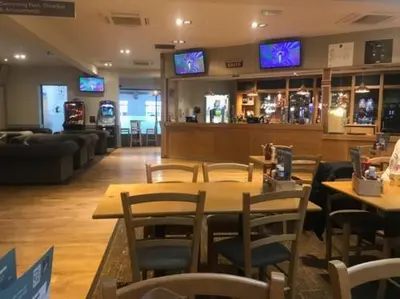 a restaurant with tables and chairs and televisions at Heywoods caravan holiday home in Morecambe