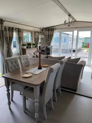 a dining room with a table and chairs at Heywoods caravan holiday home in Morecambe