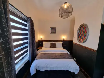 a bedroom with two beds and a window at Rendezvous Bar & Rooms - ADULTS ONLY in Blackpool