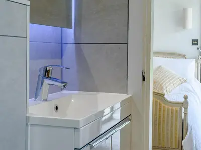 a bathroom with a sink and a mirror at The Restored Cottage in Eccleston