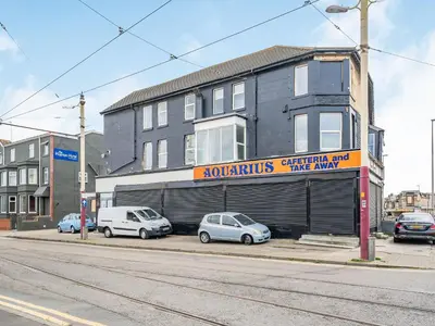 two cars parked in front of a building at Sea View Apartment Two - Uk36847 in Blackpool