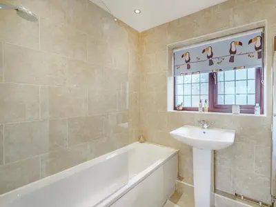 a bathroom with a sink and a bath tub and a sink at The Birds Nest in Longridge