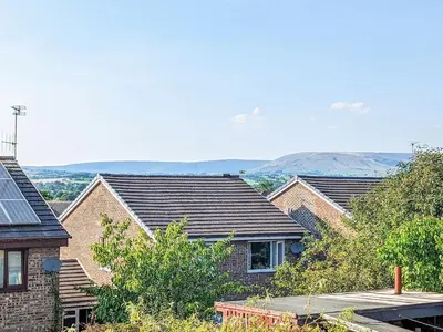 a group of houses with mountains in the background at The Birds Nest in Longridge