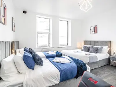 a bedroom with two beds and a couch at Sea View Apartment One - Uk36846 in Blackpool