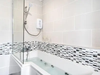 a bathroom with a bath tub and a shower at Sea View Apartment One - Uk36846 in Blackpool