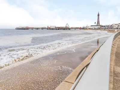 a view of the beach with a pier in the background at Sea View Apartment One - Uk36846 in Blackpool