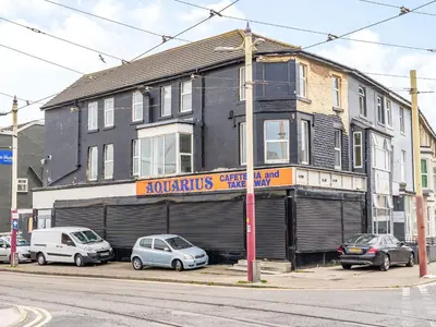 a building with cars parked in front of it at Sea View Apartment One - Uk36846 in Blackpool