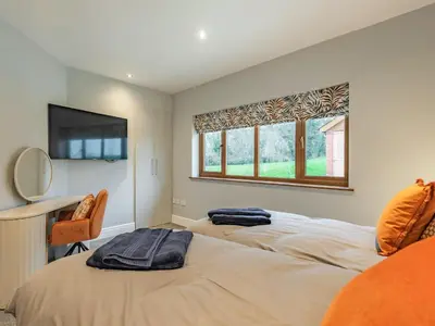 a bedroom with two beds and a window at Hoole Summer House in Elswick
