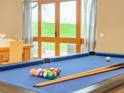 a pool table with balls and bats on it at Hoole Summer House in Elswick
