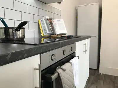 a kitchen with a stove and a counter top at Bright Spacious 3-bed with office & patio, Preston in Preston