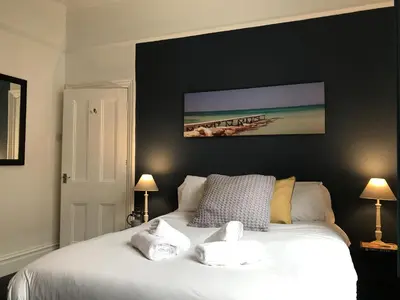 a bedroom with a white bed with two pillows at Bright Spacious 3-bed with office & patio, Preston in Preston