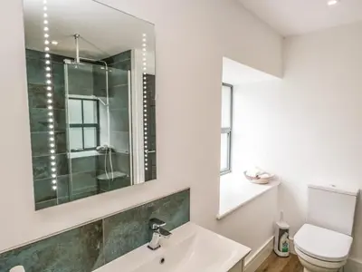 a bathroom with a sink and a toilet at Bank Hurst Coach House in Ulverston