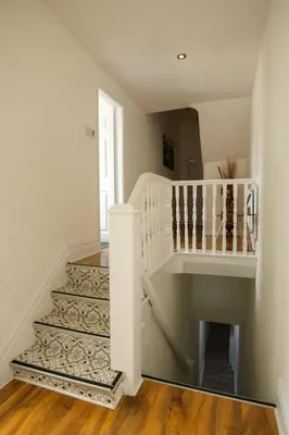 a staircase in a home with a white stair case at HOT TUB JACUZZI on private terrace FREE GATED PARKING sleeps 8 in Blackpool