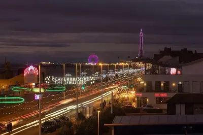 a city street at night with a tower in the background at HOT TUB JACUZZI on private terrace FREE GATED PARKING sleeps 8 in Blackpool