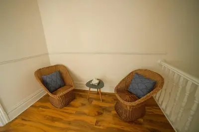 two wicker chairs and a table in a room at HOT TUB JACUZZI on private terrace FREE GATED PARKING sleeps 8 in Blackpool