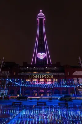 a lit up tower at night with a sign on it at HOT TUB JACUZZI on private terrace FREE GATED PARKING sleeps 8 in Blackpool