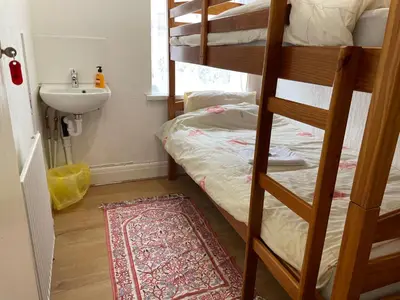 a bathroom with two bunk beds and a sink at Renovated 4-Bed Home Sleeps 9 with Parking & Spa in Blackpool