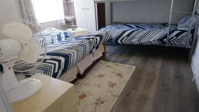 a room with two twin beds and a fan at Renovated 4-Bed Home Sleeps 9 with Parking & Spa in Blackpool