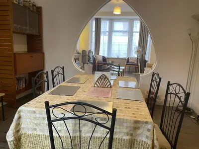 a dining room with a table and chairs at Renovated 4-Bed Home Sleeps 9 with Parking & Spa in Blackpool