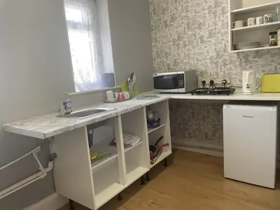 a kitchen with a sink and a microwave at Renovated 4-Bed Home Sleeps 9 with Parking & Spa in Blackpool