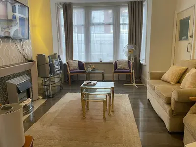 a living room with a couch and a coffee table at Renovated 4-Bed Home Sleeps 9 with Parking & Spa in Blackpool